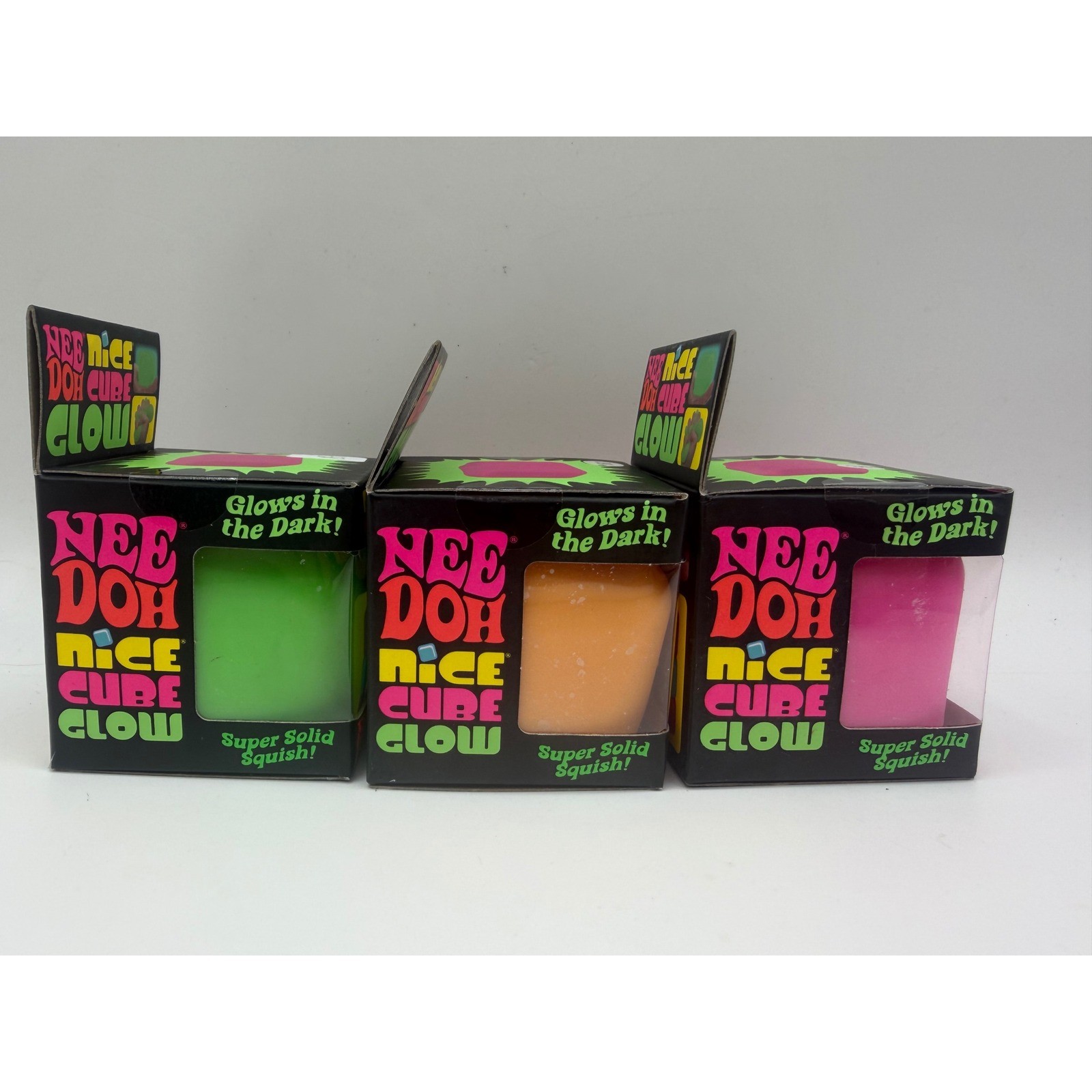 Schylling NeeDoh Nice Cube Glow Fidget Toy 3 Pack Green Orange Pink Glow In Dark