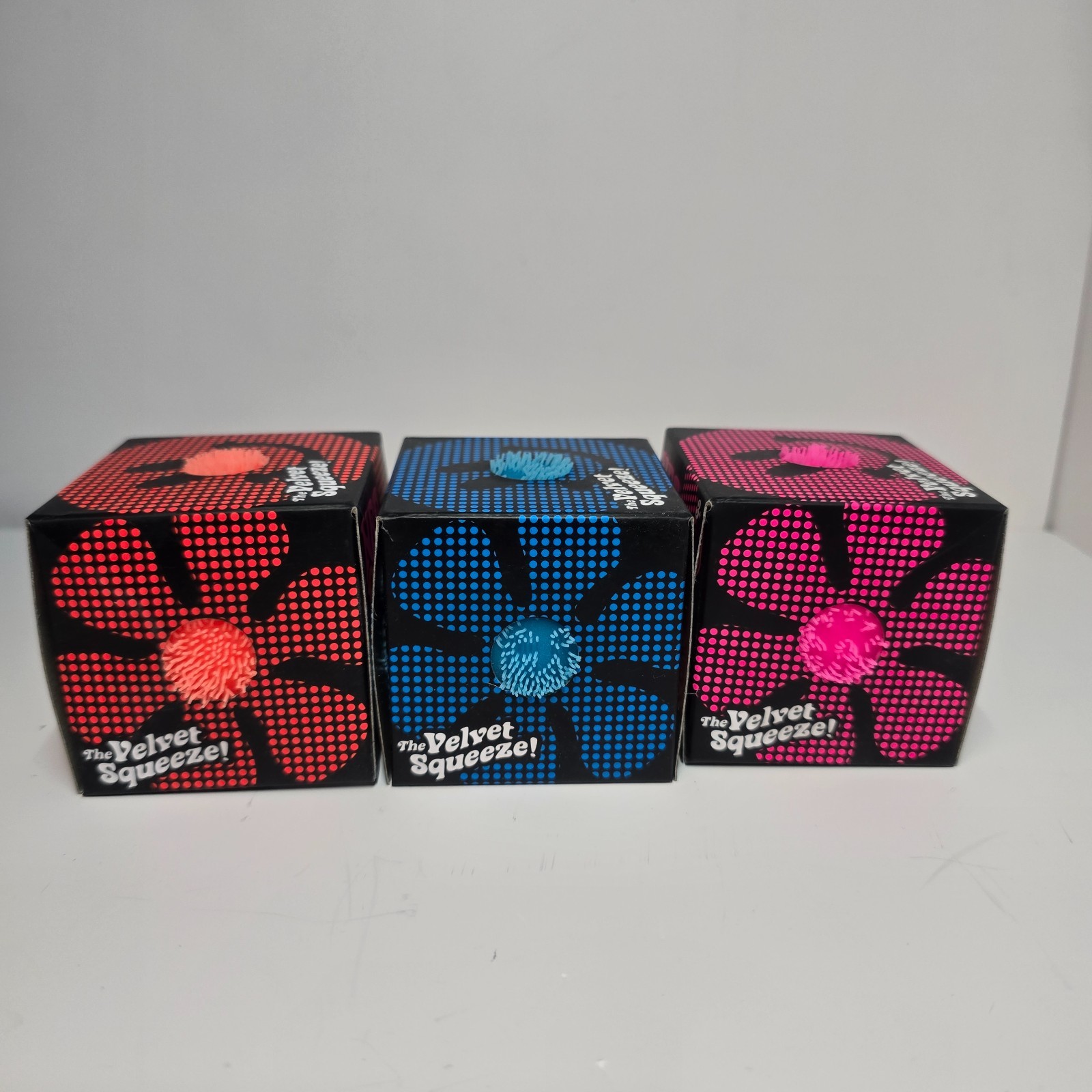 NeeDoh Schylling Fuzz Ball Flower Power in Orange, Blue and Pink