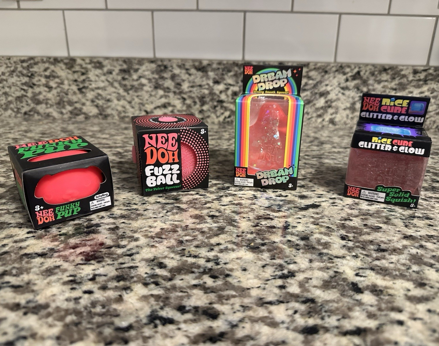 Nee Doh Squeeze Toy Bundle – Fuzz Ball, Dream Drop, Nice Cube, Red/Pink, 17+