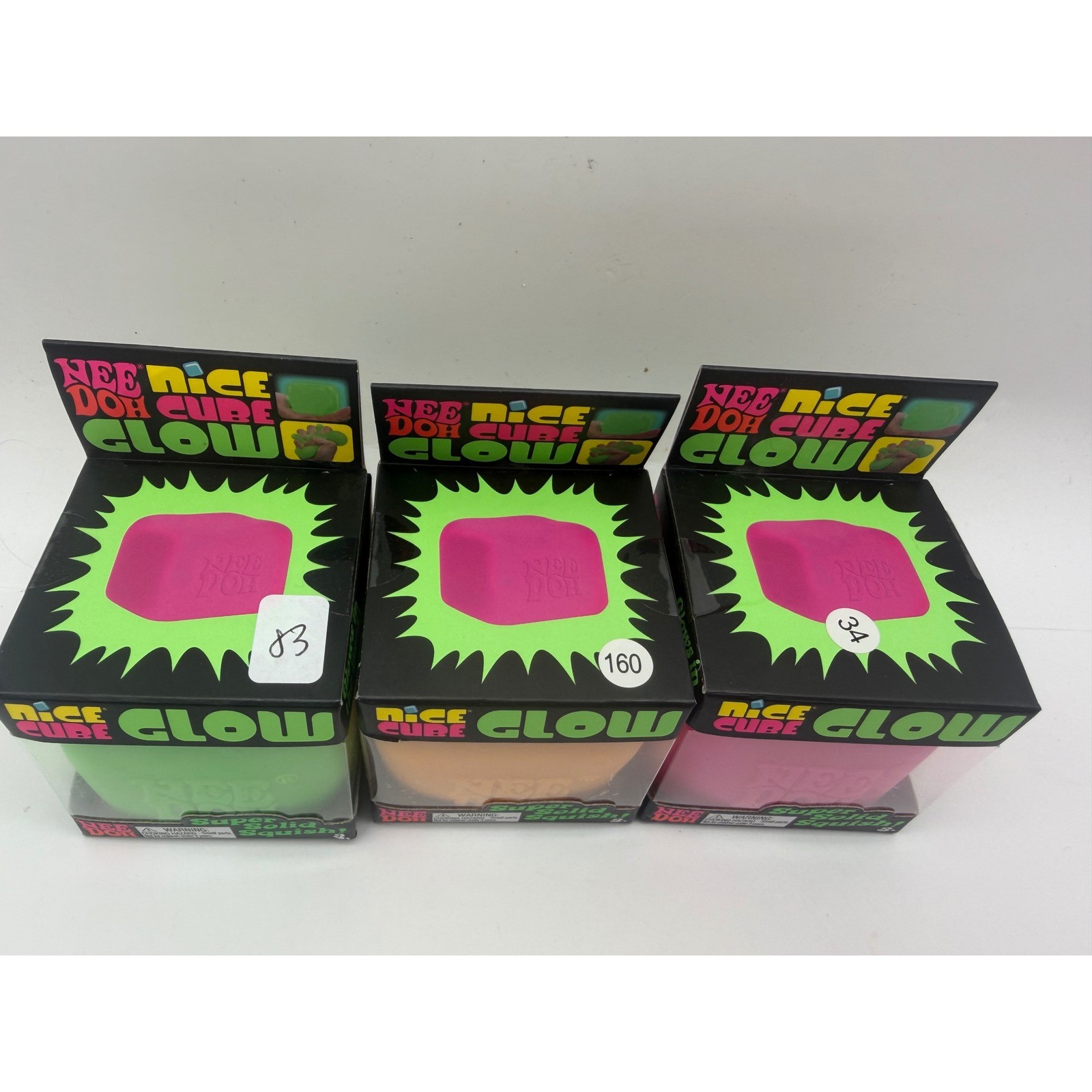 Schylling NeeDoh Nice Cube Glow Fidget Toy 3 Pack Green Orange Pink Glow In Dark