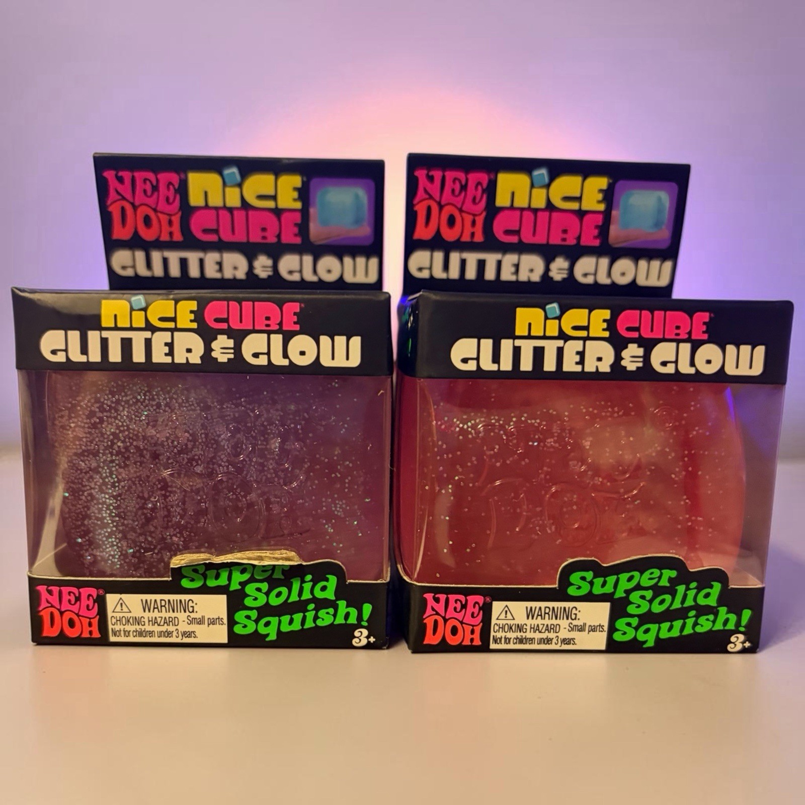 Schylling NeeDoh Nice Cube in a pink And purple “Glitter & Glow” edition