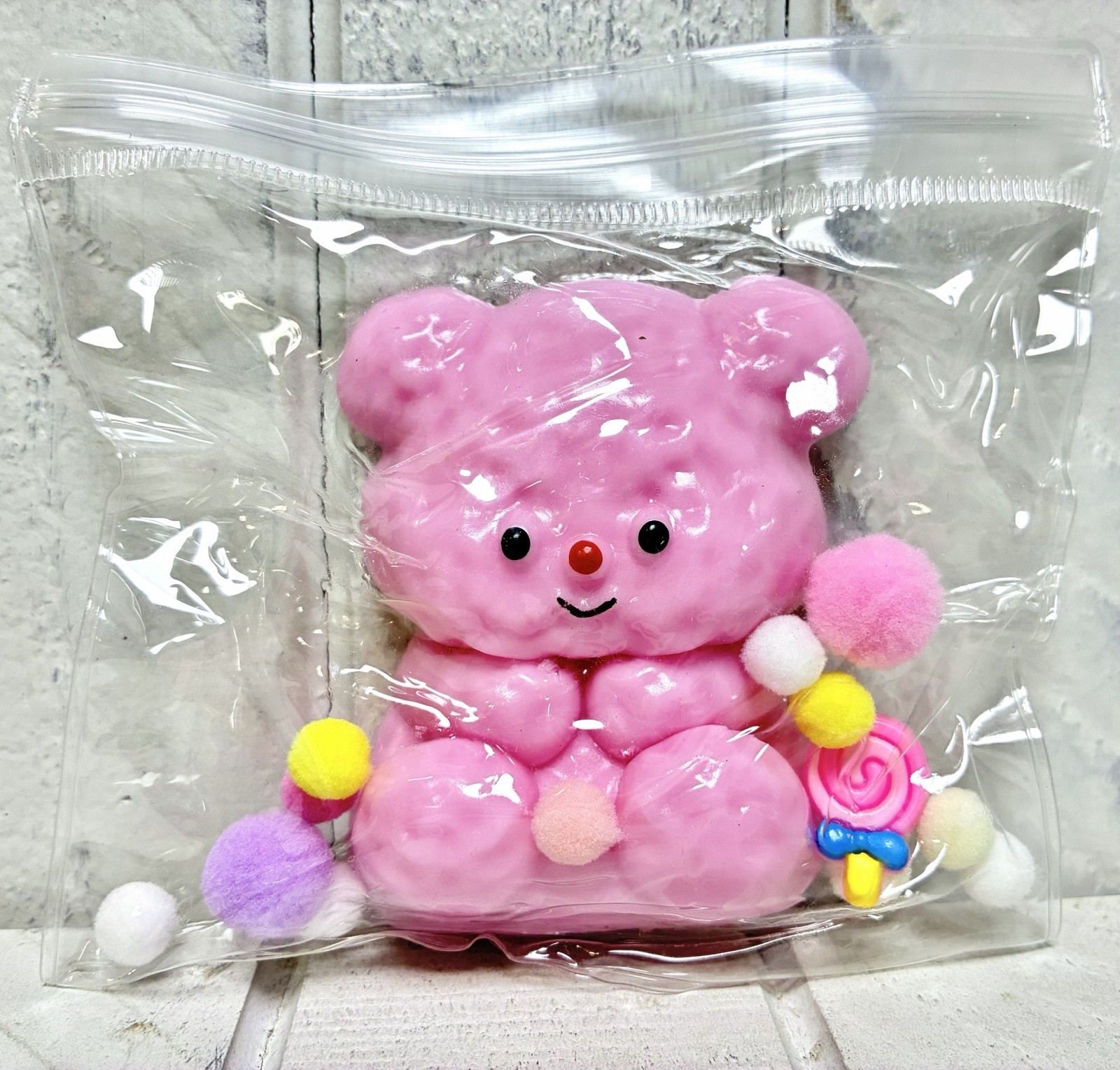 Squishy Toy Cute Pink Teddy Bear With Colorful Pom Poms In Clear Resealable Bag