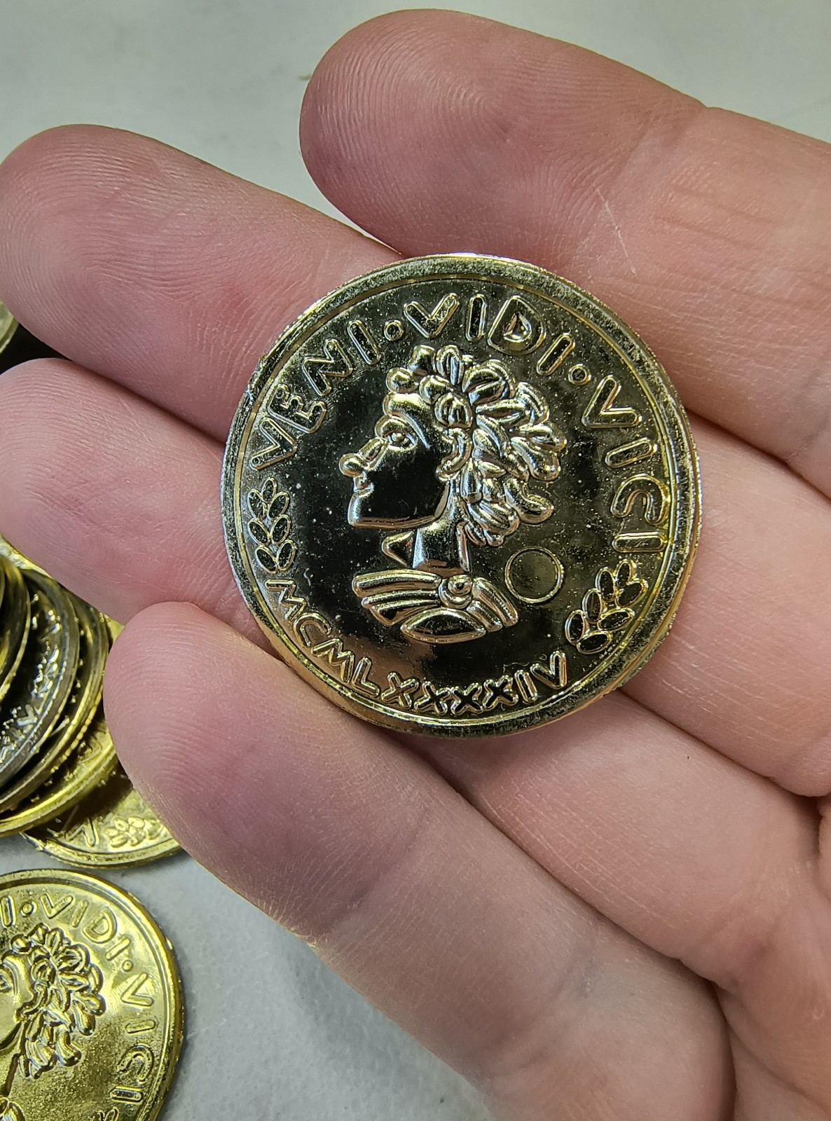 Plastic Gold Colored Toy Coins Lot of approximately – VENI VIDI VICI 2000 yr