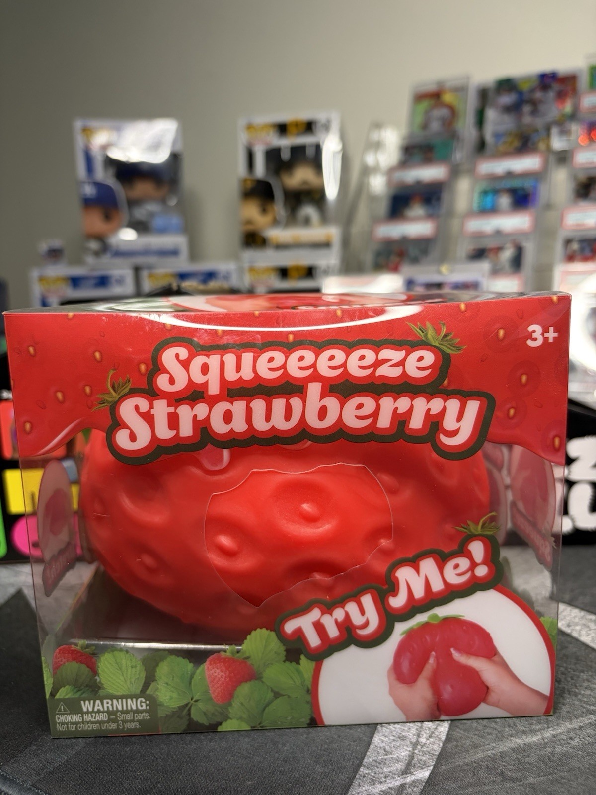 Squeeeeze Strawberry Tactile Squeeze Poke Squish Toy, Try Me, Red/Green 3+