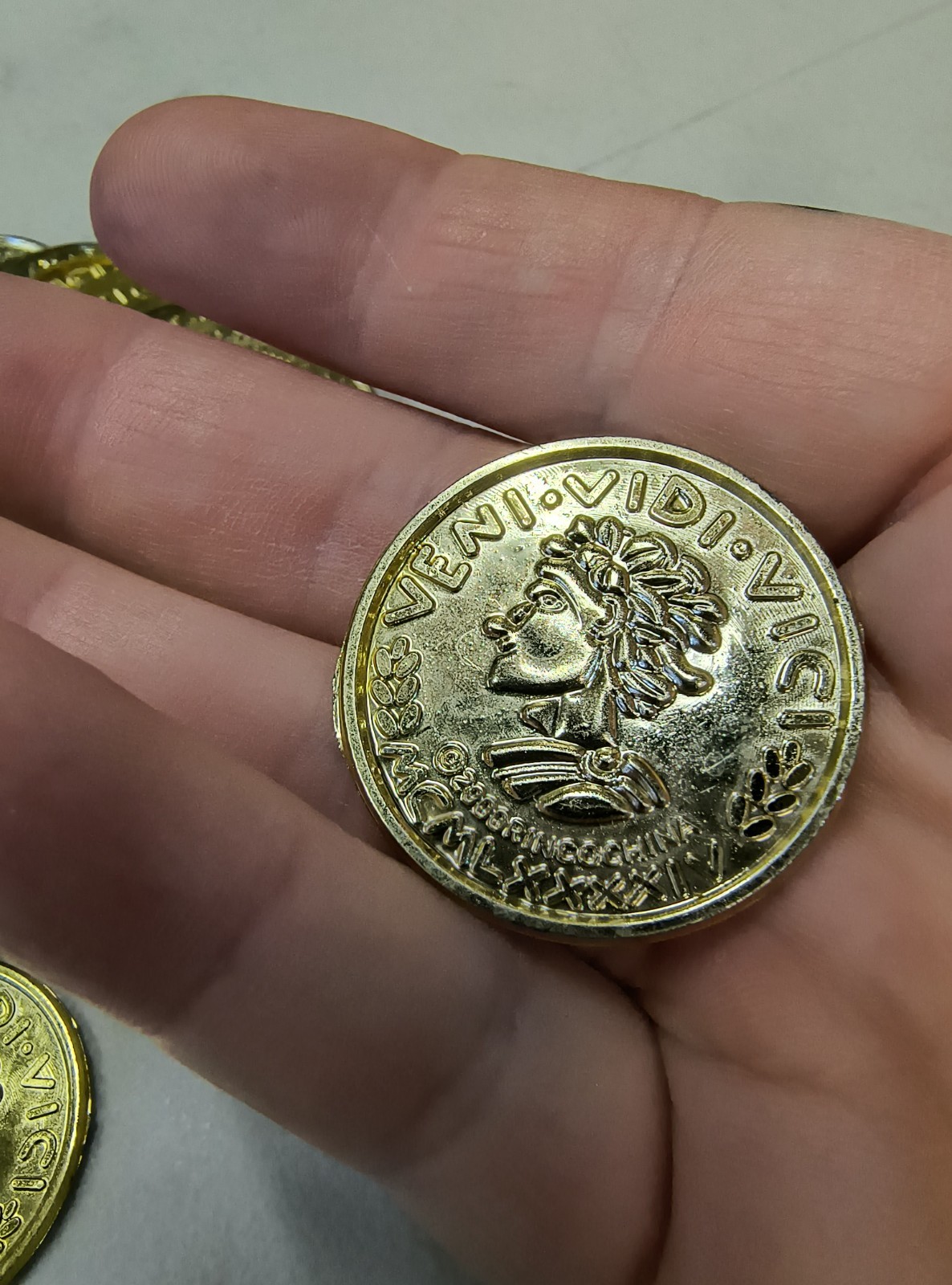 Plastic Gold Colored Toy Coins Lot of approximately – VENI VIDI VICI 2000 yr