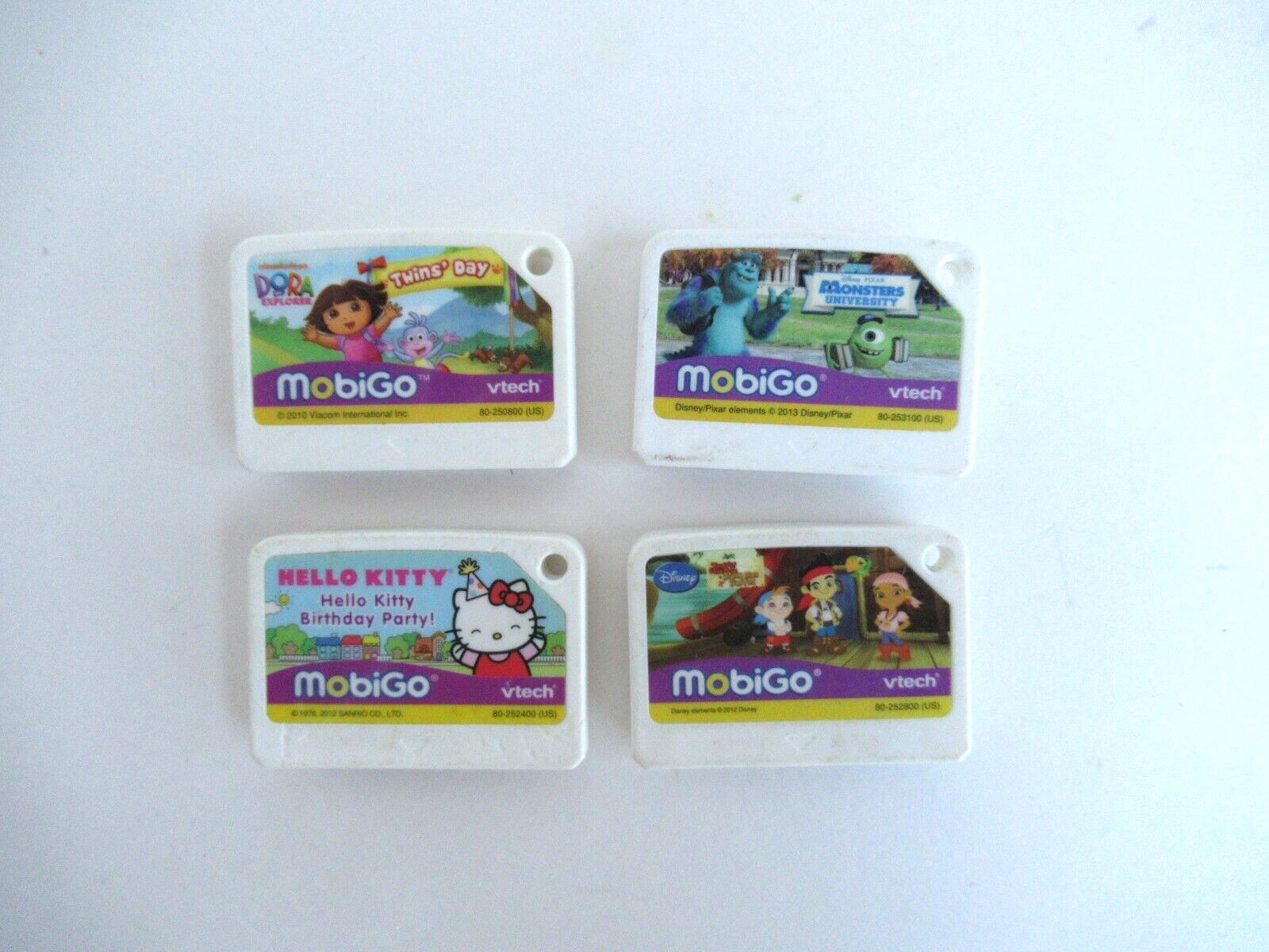 Lot Of 4 Vtech MobiGo Games Jake & Pirates, Monster University Dora Hello Kitty