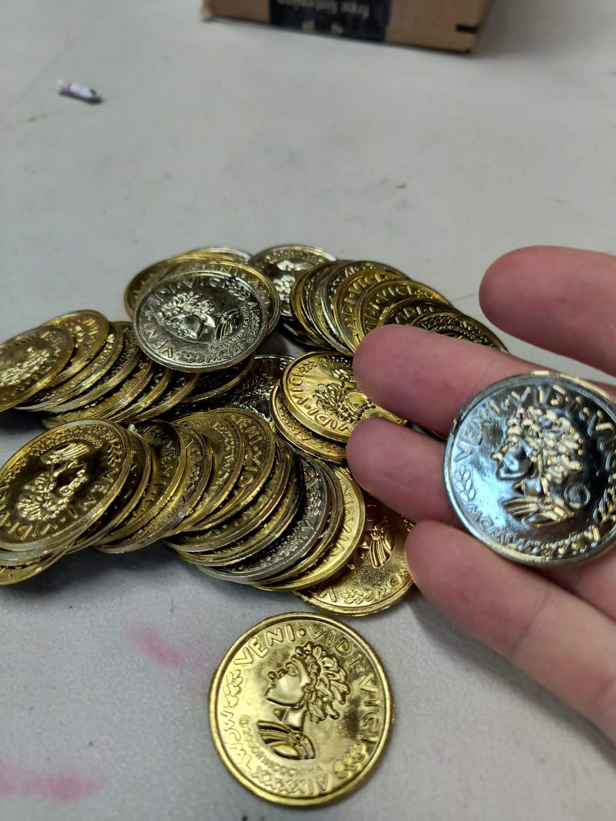Plastic Gold Colored Toy Coins Lot of approximately – VENI VIDI VICI 2000 yr