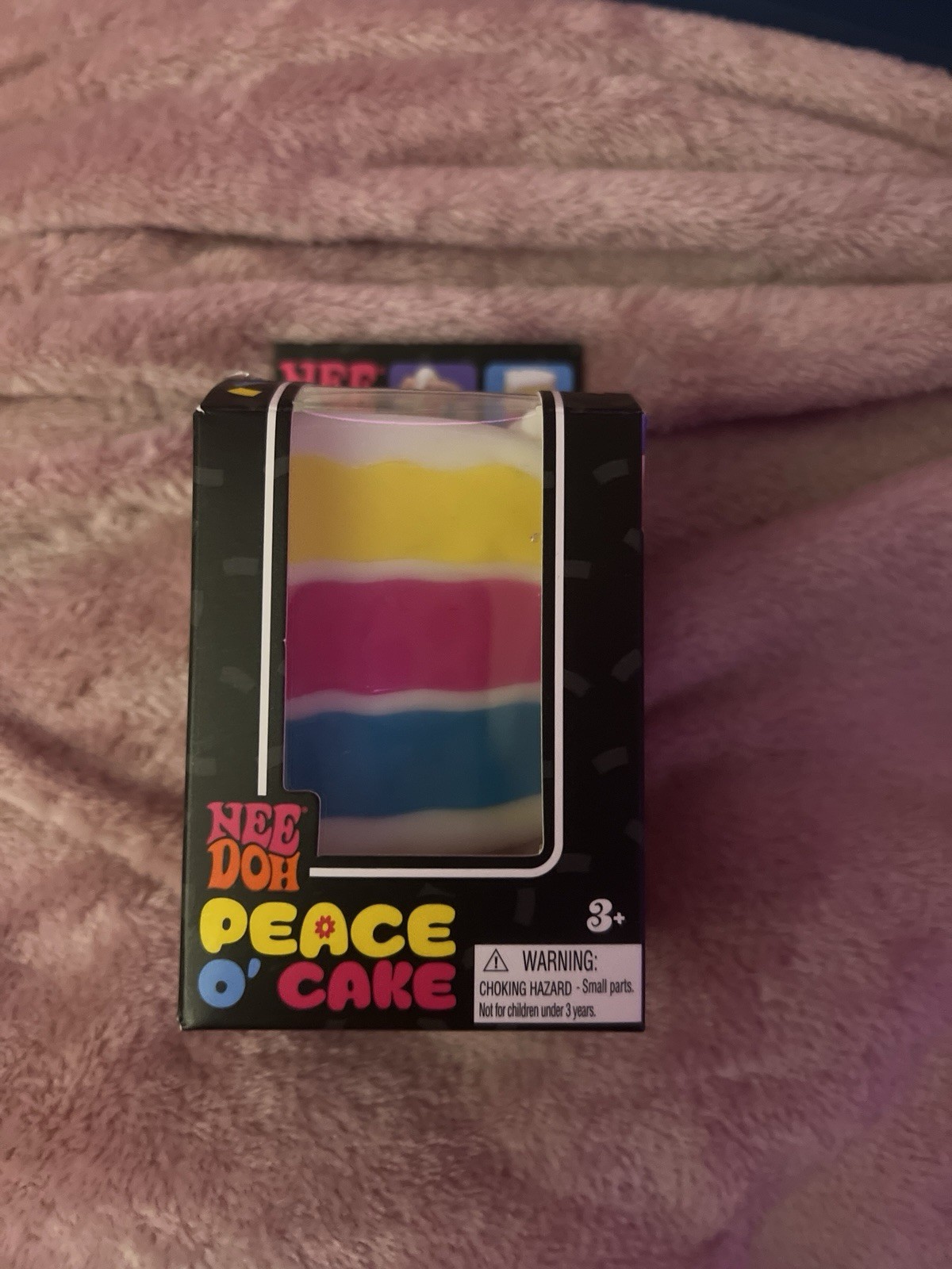 Nee Doh Peace O’ Cake Tactile Squeeze Toy Multicolor White Yellow Pink Blue