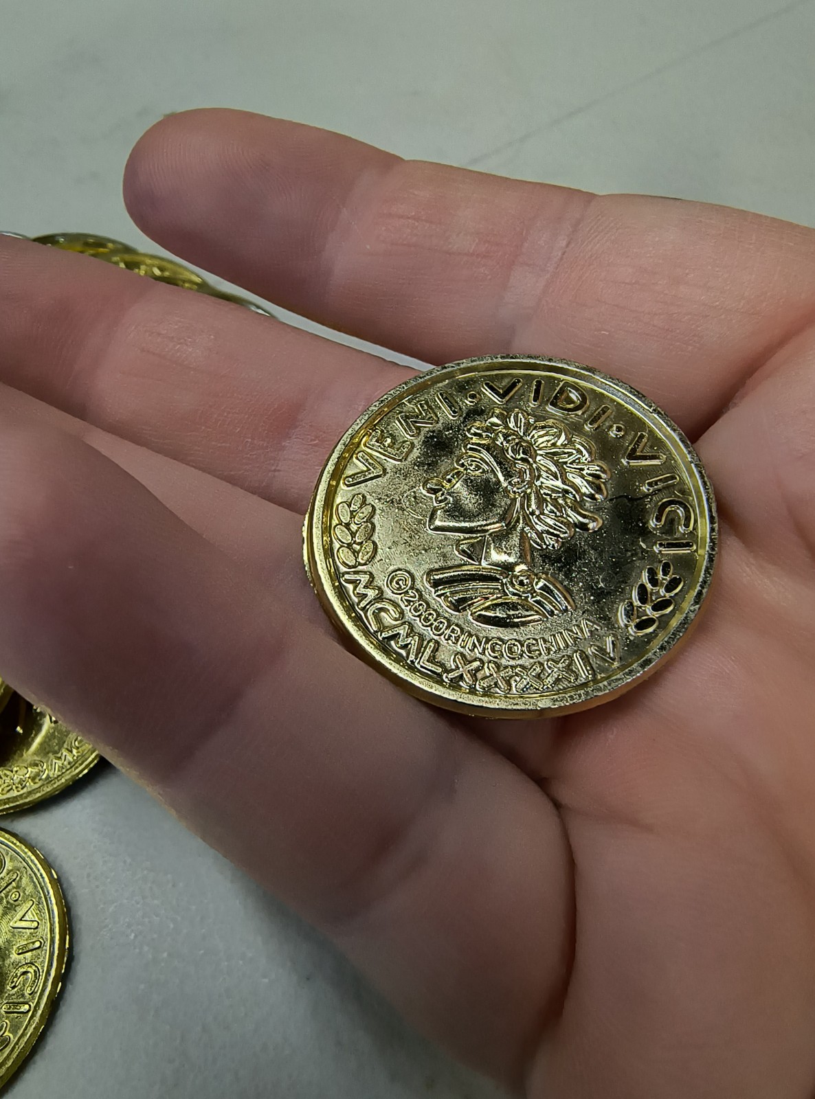 Plastic Gold Colored Toy Coins Lot of approximately – VENI VIDI VICI 2000 yr