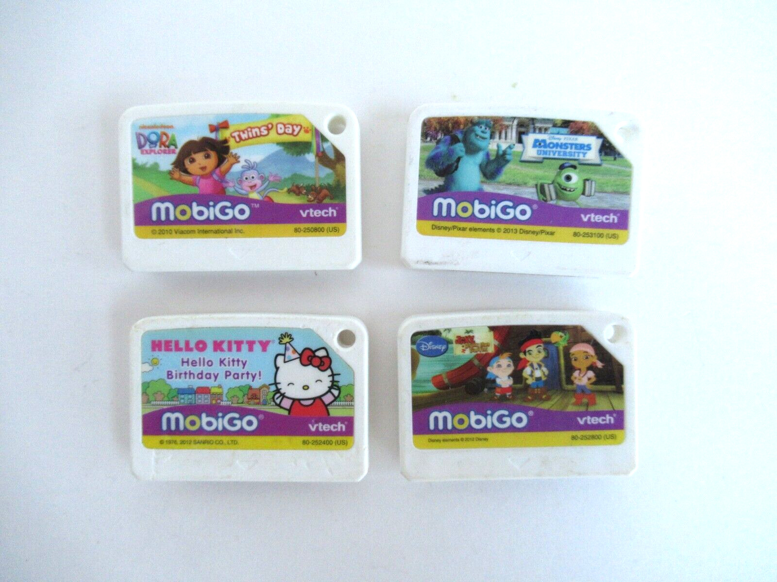 Lot Of 4 Vtech MobiGo Games Jake & Pirates, Monster University Dora Hello Kitty