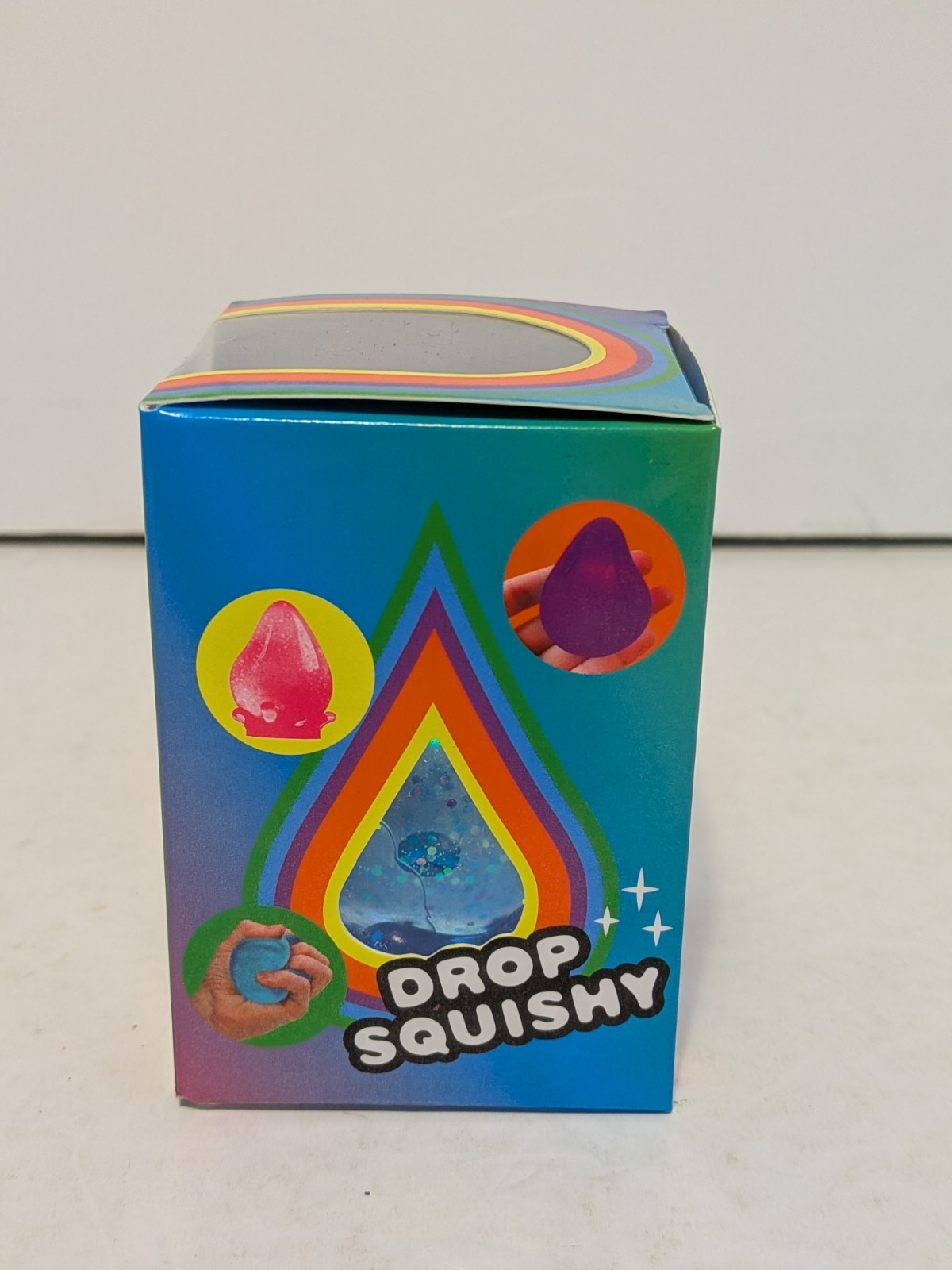 Drop Squishy Blue Glitter Tactile Squishy Squeeze Toy w/ Splash Display Stand