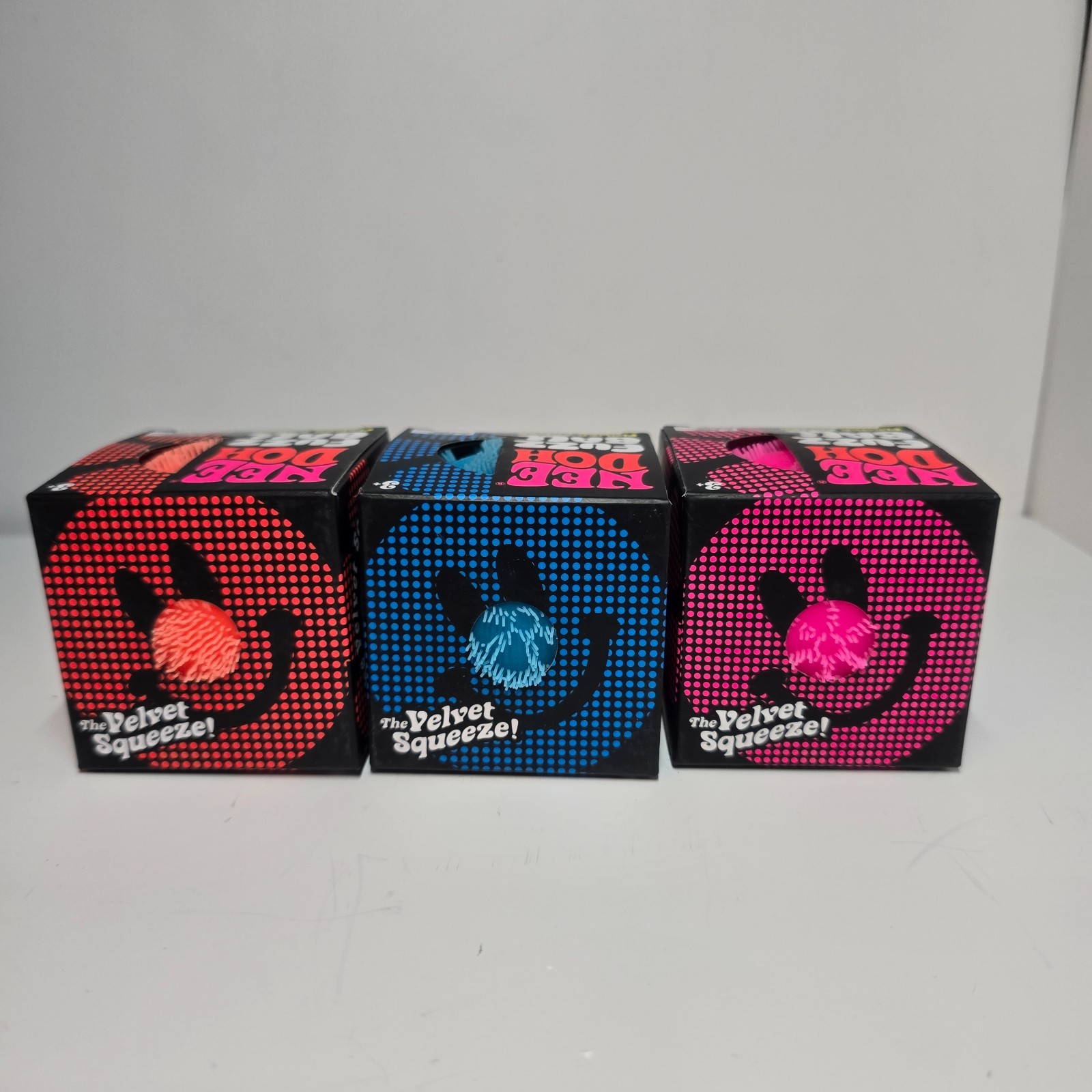 NeeDoh Schylling Fuzz Ball Flower Power in Orange, Blue and Pink