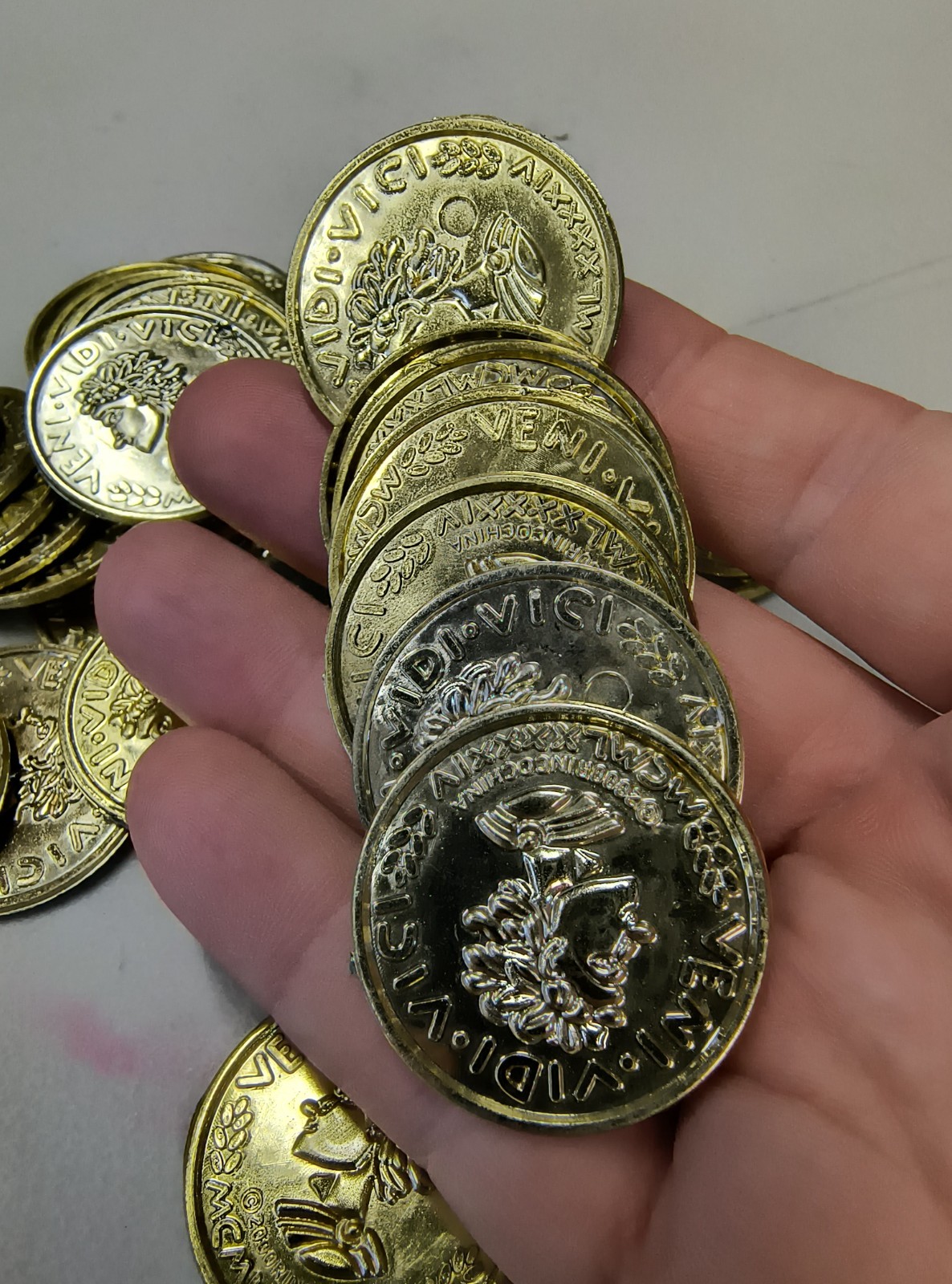 Plastic Gold Colored Toy Coins Lot of approximately – VENI VIDI VICI 2000 yr