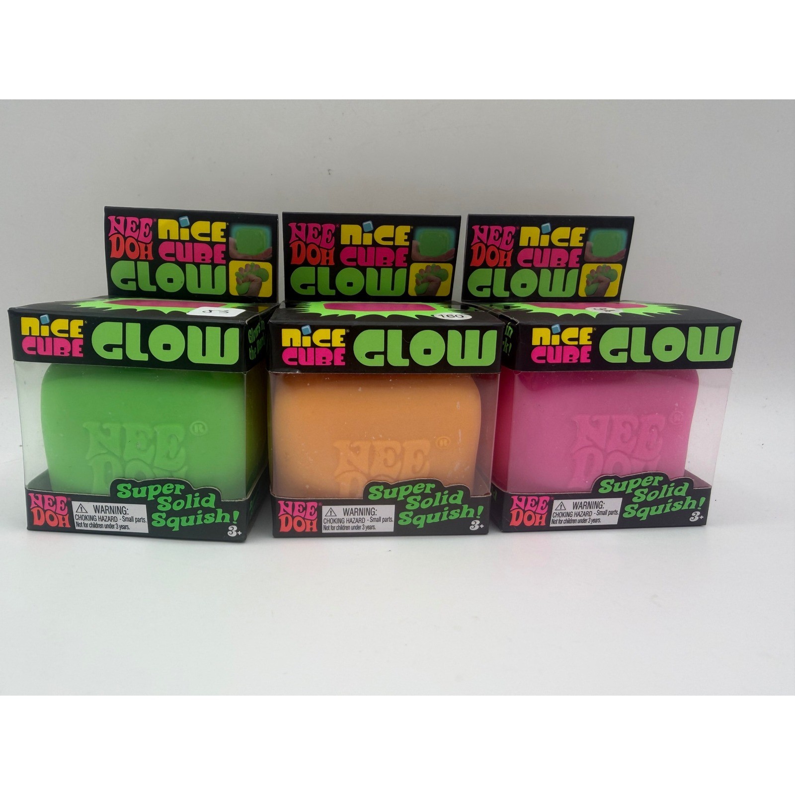 Schylling NeeDoh Nice Cube Glow Fidget Toy 3 Pack Green Orange Pink Glow In Dark
