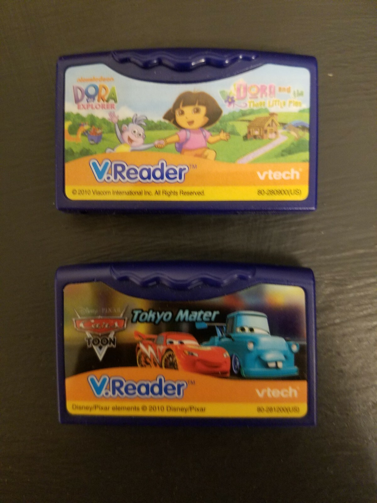 2 Vtech Games V.Reader – Dora and 3 little pigs – Tokyo Mater – Ages 5 to 7