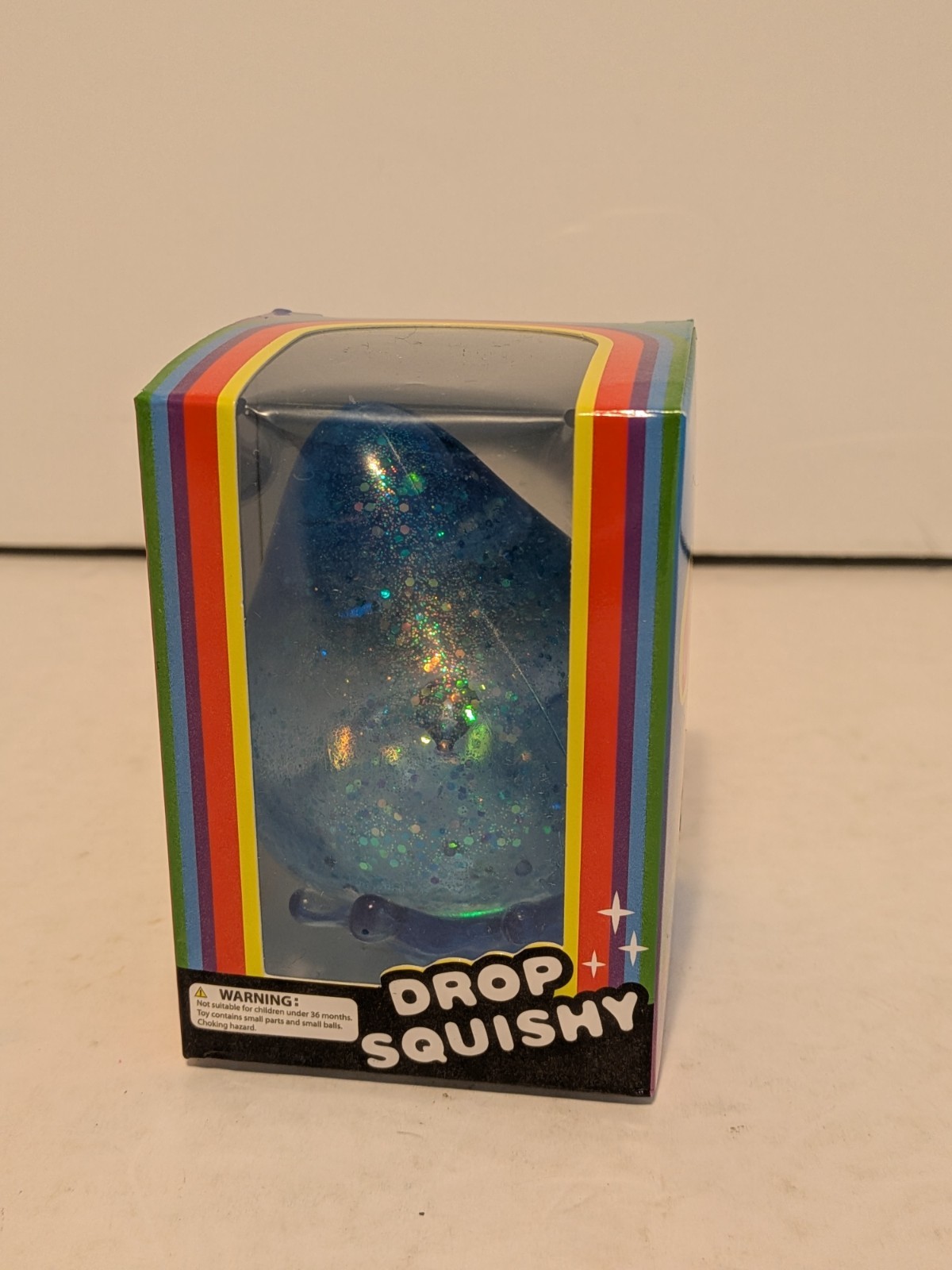 Drop Squishy Blue Glitter Tactile Squishy Squeeze Toy w/ Splash Display Stand