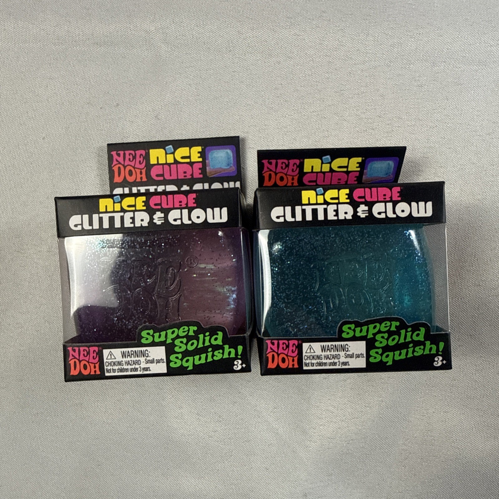 NeeDoh Nice Cube Glitter and Glow, Squishy, Glowing Ice Cube Pink And Blue